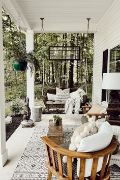 a porch with furniture and pillows on it