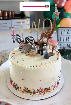 a birthday cake decorated with animals and letters