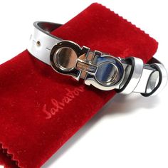 New$460 Salvatore Ferragamo Gancini Metallic Leather Bracelet In Silver Size: 10" Full Length, 4 Holes, 6 3/4" (First Hole) - 7 7/8" (Last Hole); 1/2" Width Made In Italy Brand New W/O Tag! 100% Authentic!!! Logo-Inscribed Gancini Hardware Doubles The Silvery Shine Of This Leather Bracelet With Two Belt-Like Keepers. 100% Calf Leather Silver-Tone Plate Hook And Hole Closure 6 3/4" - 7 7/8" Length; 1/2" Width Brand New W/O Tag With Ferragamo Pouch And Saks Fifth Ave Jewelry Box!! * Ship Fast On S Luxury Formal Bracelet With Stainless Steel Clasp, Luxury Bracelets With Stainless Steel Clasp For Formal Occasions, Formal Luxury Bracelet With Metal Clasp, Silver Leather Bracelets For Formal Occasions, Luxury White Gold Bracelets With Silver-tone Logo, Formal Silver Leather Bracelets, Formal Bracelets With Stainless Steel Clasp, Luxury Formal Jewelry With Stainless Steel Clasp, Elegant Formal Jewelry With Silver-tone Hardware