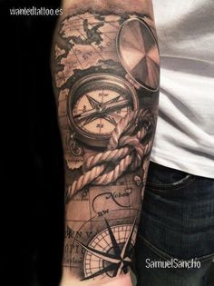 a man with a compass and rope tattoo on his arm