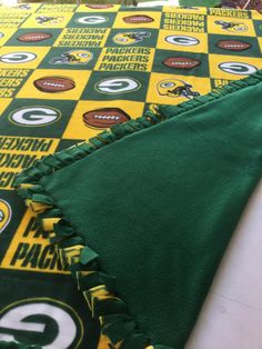 the green bay packers blanket is laying on the floor