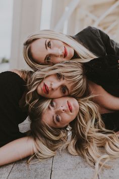 three beautiful women laying on the ground together