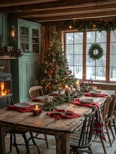 a dining room table set for christmas dinner with candles and wreaths on the windowsill