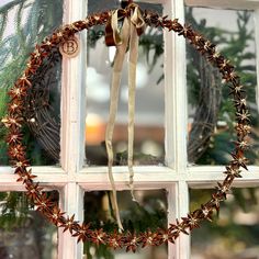 a wreath hanging on the side of a window