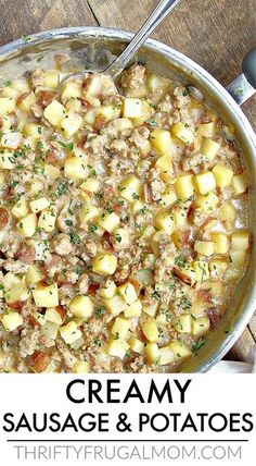 creamy sausage and potatoes in a skillet on a wooden table with a serving spoon