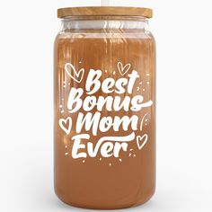 a glass jar with the words best mom ever written in white on it and a wooden lid