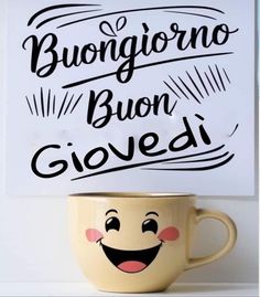 a coffee cup with a sign above it that says buon buon giovedi