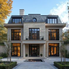 a large house with lots of windows and landscaping