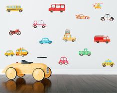 a child's room with cars and trucks wall decals on the walls, along with a wooden toy car