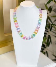 Introducing our Lucite Resin Chain Link Necklace, a stunning piece of jewelry that will add a touch of elegance to any outfit. The necklace features a series of multi-color translucent links made from lucite resin, each link interlocking with the next to form a beautiful chain.
Measuring 18.5" in length with an additional 3.5" of extension chain, this necklace can be adjusted to your desired length. The centerpiece of the necklace measures 0.7" in length, adding just the right amount of size and Multicolor Plastic Jewelry With Adjustable Chain, Multicolor Plastic Jewelry For Party, Colorful Plastic Jewelry For Party, Multicolor Paperclip Chain Necklace For Gift, Multicolor Paperclip Chain Necklace As Gift, Multicolor Paperclip Chain Necklace Gift, Trendy Clear Jewelry With Chain, Trendy Multicolor Glass Necklaces, Trendy Multicolor Glass Necklace