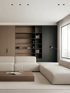 a living room filled with furniture and bookshelves next to a wall mounted book shelf