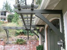 an outside view of a house with a pergolated roof