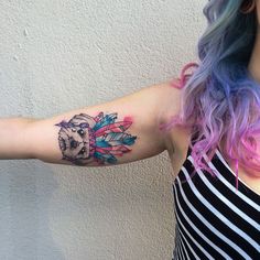 a woman with a tattoo on her arm