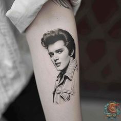 a woman's arm with a black and white portrait tattoo on the left forearm