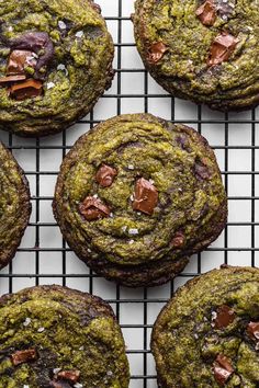 chocolate chip cookies on a cooling rack with green frosting and sprinkles