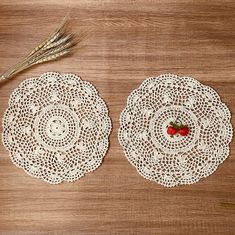 two white doily plates with strawberries on them