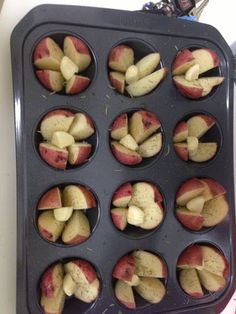 apples are being cooked in a muffin tin