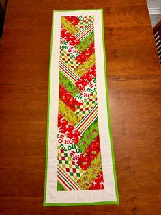 the table runner is made with red, green and white fabric