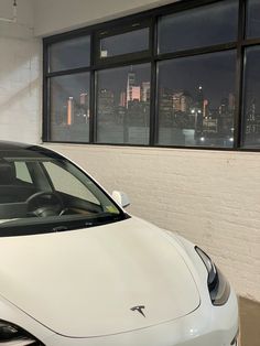 a white car parked in front of a window