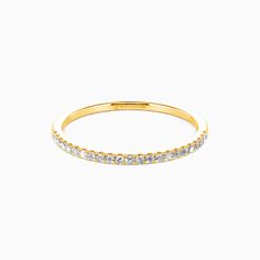 a yellow gold band with white diamonds on the inside and outside, set against a plain background