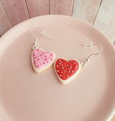 "A pair of handmade heart shaped sugar cookie earrings iced with pink and red icing and topped with white, red and pink sprinkles.  -hearts measure 3/4\" -earring hooks are nickel free -earrings come with soft silicone backings All of my jewelry comes gift wrapped inside a padded jewelry box and is shipped via USPS First Class Mail in a bubbled mailer." Heart-shaped Polymer Clay Earrings For Valentine's Day, Pink Heart-shaped Polymer Clay Earrings, Valentine's Day Heart-shaped Polymer Clay Earrings, Sweet Pink Heart-shaped Earrings, Pink Polymer Clay Earrings For Valentine's Day, Heart-shaped Polymer Clay Earrings For Gifts, Polymer Clay Heart Earrings As Gift, Cute Polymer Clay Earrings For Valentine's Day, Handmade Sweet Heart Earrings