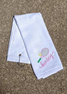 two personalized tennis towels on the ground