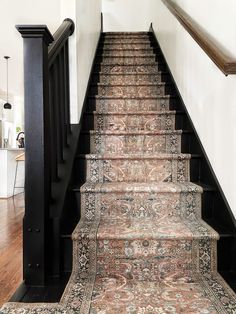 a carpeted staircase leading up to the second floor