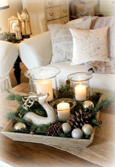 a tray filled with candles sitting on top of a table next to a white couch