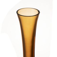 a tall brown glass vase sitting on top of a table