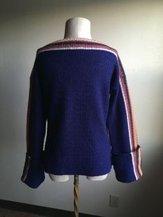 "1970s pullover long sleeve knit sweater label- Susie's 60% acrylic, 20% wool, 20% mohair made in Italy deep blue w/multi-color striped detail xtra long sleeves 2 front pockets soft and fuzzy light age wear, light pilling label size L actual measurements, lying flat, shoulder-22\" shoulder to sleeve (cuffed)-23\" chest-20\" length-24\" original one of a kind with an retro art deco style fisher(wo)man vibe" Winter Long Sleeve Sweater With Striped Cuffs, Winter Knit Sweater With Striped Cuffs, Knit Sweater With Striped Cuffs For Winter, Long Sleeve Cardigan With Striped Cuffs For Fall, Fall Cardigan With Striped Cuffs And Long Sleeves, Winter Knit Tops With Striped Cuffs, Knit Tops With Striped Cuffs For Winter, Blue Winter Sweater With Striped Cuffs, Striped Knit Sweater For Fall