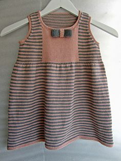 a knitted dress hanging on a hanger