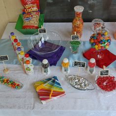 the table is covered with candy and candies