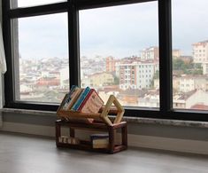 a wooden bench sitting in front of a window filled with books