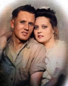 an old photo of a man and woman posing for a picture together in front of a gray background