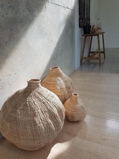 two vases sitting on the floor next to each other