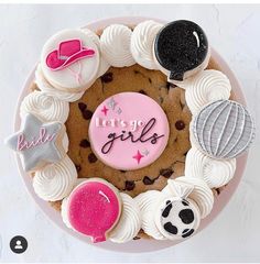 there is a cake decorated with cookies and other things on it that say let's go girls