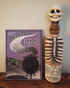 a skeleton statue next to a book on a shelf