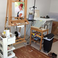 an artist's studio with easel, canvas and other art supplies