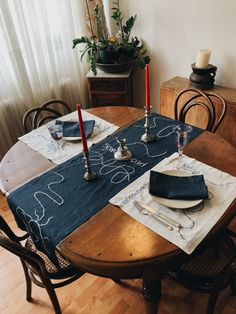 the table is set with place settings for two people to sit at, and there are candles on it