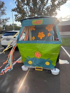 an ice cream van is parked in a parking lot with streamers on the ground