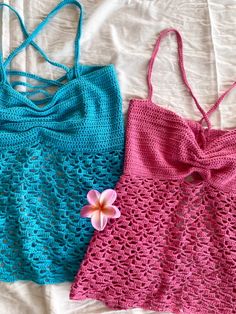 two crocheted swimsuits laying next to each other