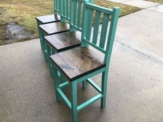 three wooden chairs sitting next to each other