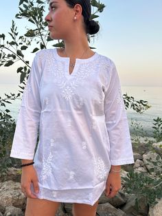 Hand embroidered cotton tunic Non-stretch Cotton Beach Top, White V-neck Blouse With Chikankari Embroidery, Elegant Spring Straight Kurta Tops, Relaxed Fit Blouse With Floral Embroidery, Elegant Straight Kurta Kaftan For Summer, Cotton Straight Kurta With Embroidered Neckline, Summer V-neck Tunic With Chikankari Embroidery, Elegant White Kurta With Embroidered Neckline, Cotton Straight Kurta Dress With Embroidered Neckline