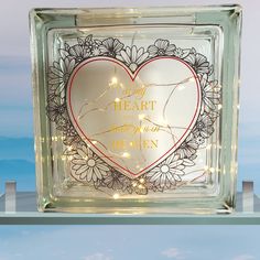 a glass block with a lighted heart on it