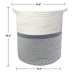 a large white and grey basket sitting on top of a table next to a ruler