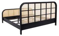 the bed frame is made from black wood and has wicker panels on top of it