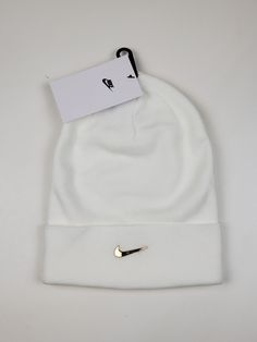 Nike Air Sportswear Metal Swoosh Cuffed Beanie Hat SAIL Metallic Gold One size Sports Beanie For Winter, Casual Sports Hat For Winter, Casual Winter Sports Hat, White Beanie Hats For Streetwear, Warm Sports Beanie Hat, Nike Winter Beanie Hat, Solid Winter Sports Hats, White Beanie For Streetwear, White Casual Beanie For Outdoor