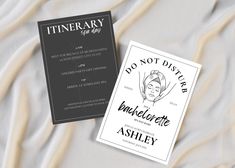 two business cards sitting on top of a white bed sheet next to each other with the words do not disturb in cursive writing