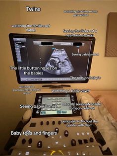 a baby monitor sitting on top of a bed in front of a tv with the words twins below it