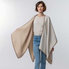 Our Vienna Cape, a true statement piece for the modern fashion enthusiast. Designed with a double-weave construction and adorned with sophisticated alcantara trim, this reversible cape radiates elegance and style from every angle. The Vienna Cape effortlessly elevates your outfit with its sleek silhouette. Embrace the look of modern sophistication with the Vienna Cape, a wardrobe essential that seamlessly transitions from day to night. Dimensions: 50 in. x 30 in. Materials: 100% baby alpaca, 100 Elegant Beige Cape Poncho, Elegant Beige Poncho, Elegant Beige Wool Cape, Double Weave, Suri Alpaca, Fashion Enthusiast, Heavy Knit, Baby Alpaca, Luxury Goods